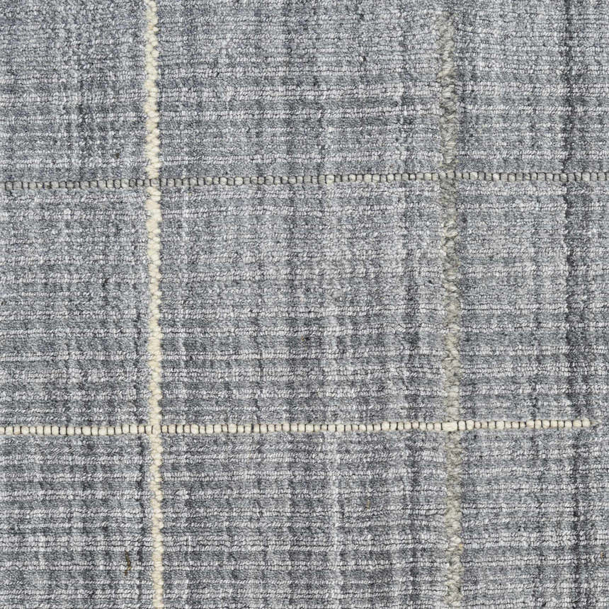 Close-up of the Calvin Klein CK041 Architectura Denim Rug. Farmhouse style rug with a textured denim color and subtle grid pattern.