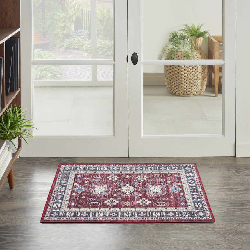 Entryway with Nourison Fulton Red Vintage Indoor Area Rug, wood floors, and white double doors to a patio.
