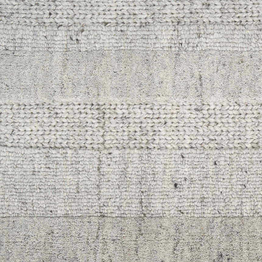 Close-up of the grey DKNY Pure Multi Weave rug showing the contemporary design and woven texture.