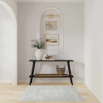 Entryway with black console table and light grey vintage Nourison Astra area rug.
