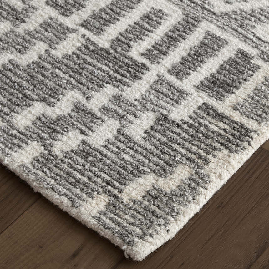 Close-up of the hand-tufted Feizy Asher rug in gray and white, showcasing the transitional distressed pattern and wool texture. Corner