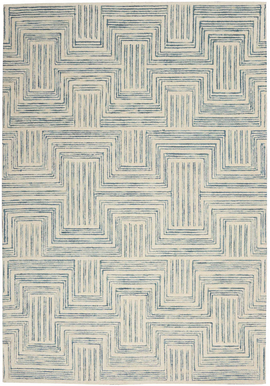 Close-up of the Nourison Interlock Ivory/Turquoise rug. Features a geometric, mid-century modern pattern in shades of blue on an ivory base.