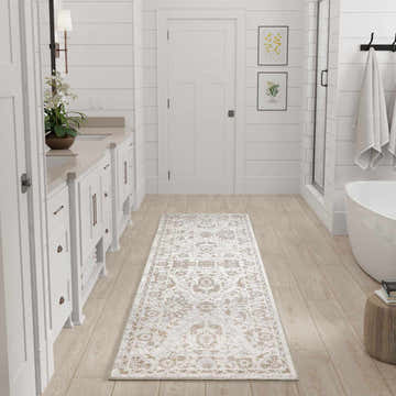 Bathroom scene with Nourison Astra Grey Vintage runner rug, white cabinets, and light wood floors.