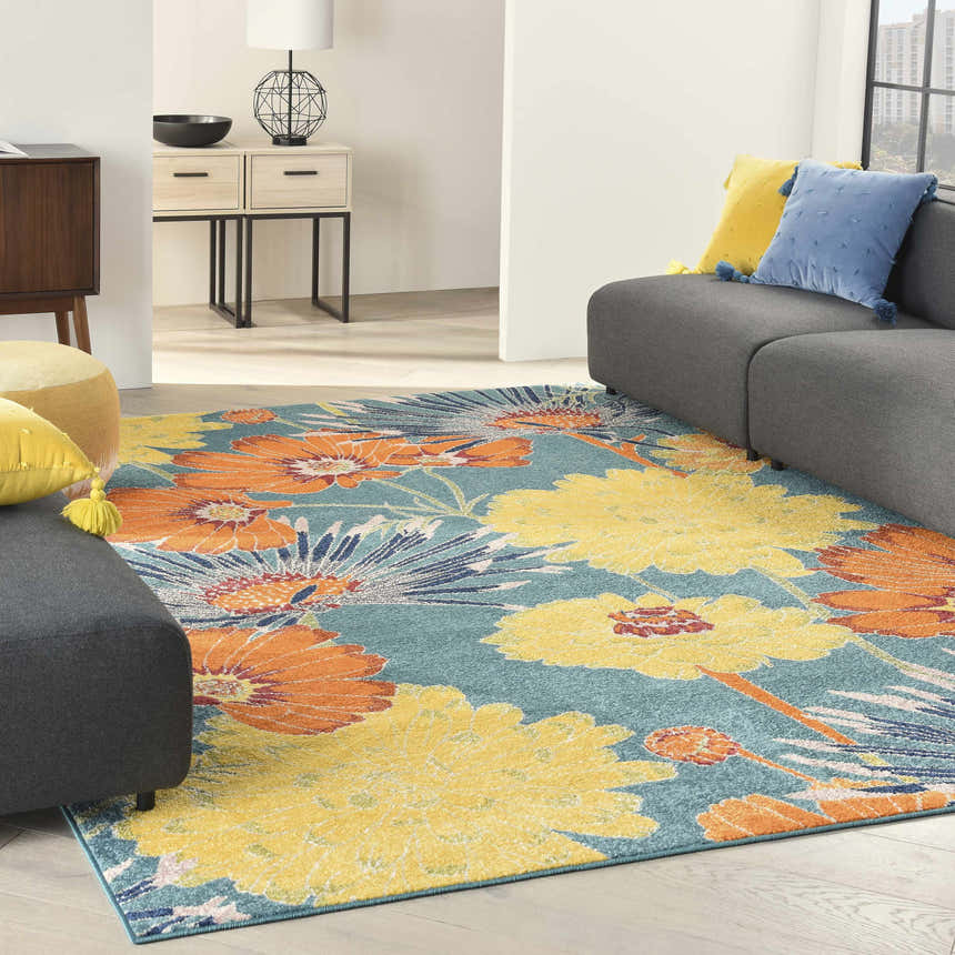 Living room scene with gray sofa and the Nourison Allur Turquoise Multicolor rug featuring large floral pattern.