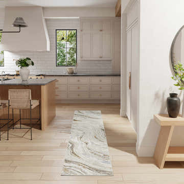 Light and airy kitchen with Nourison Glitz Grey Gold runner rug, wood floors, island, and neutral cabinets.