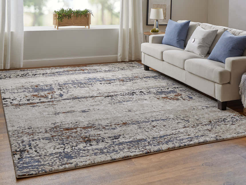 Living room scene with Feizy Gilmore Ivory/Blue/Gray rug, neutral sofa, blue pillows, and wood floors. Roomscene-Rectangle
