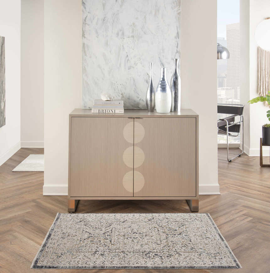 Entryway with a Nourison Lynx Ivory Charcoal Vintage Indoor Area Rug, wood floors, and modern cabinet.
