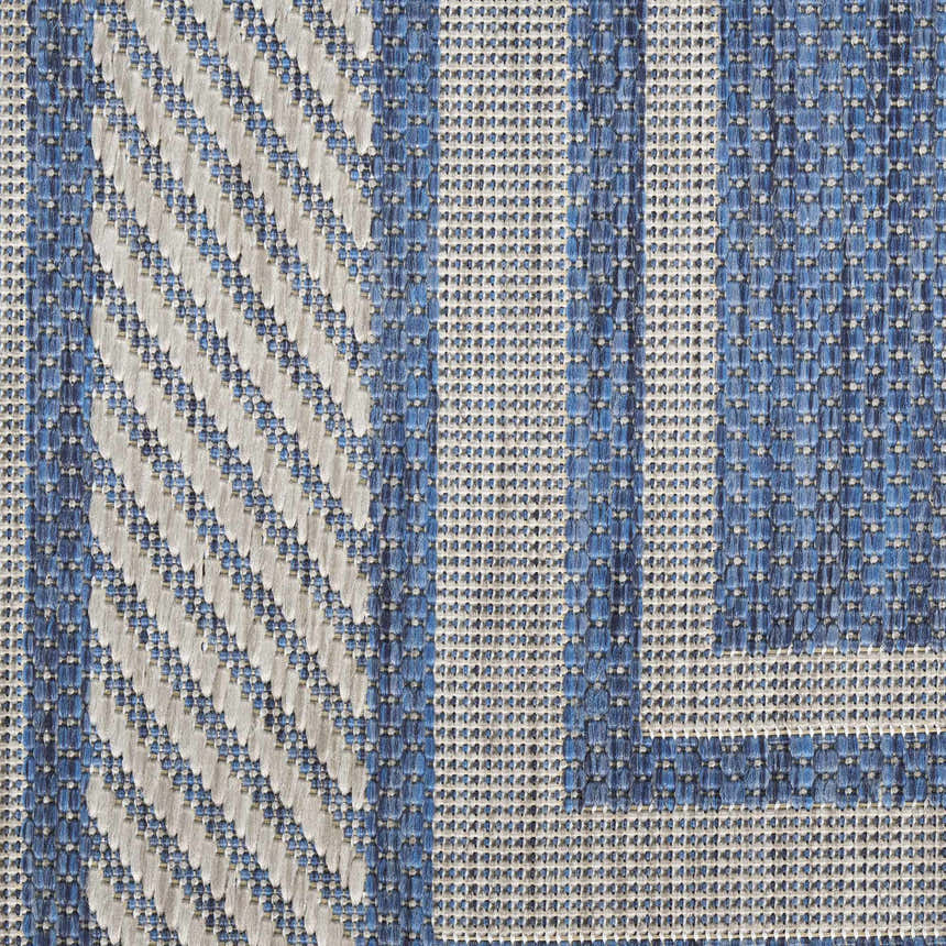 Close-up of the Nourison Horizon Denim Area Rug showing blue and white geometric patterns and woven texture.