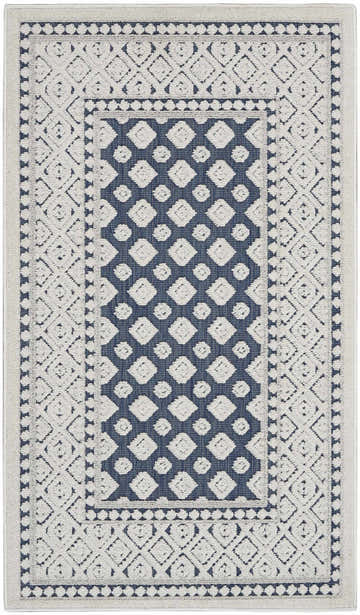 Close-up of Nourison Key Largo Blue Transitional Area Rug. Farmhouse style with diamond and dot pattern. Light blue and white.
