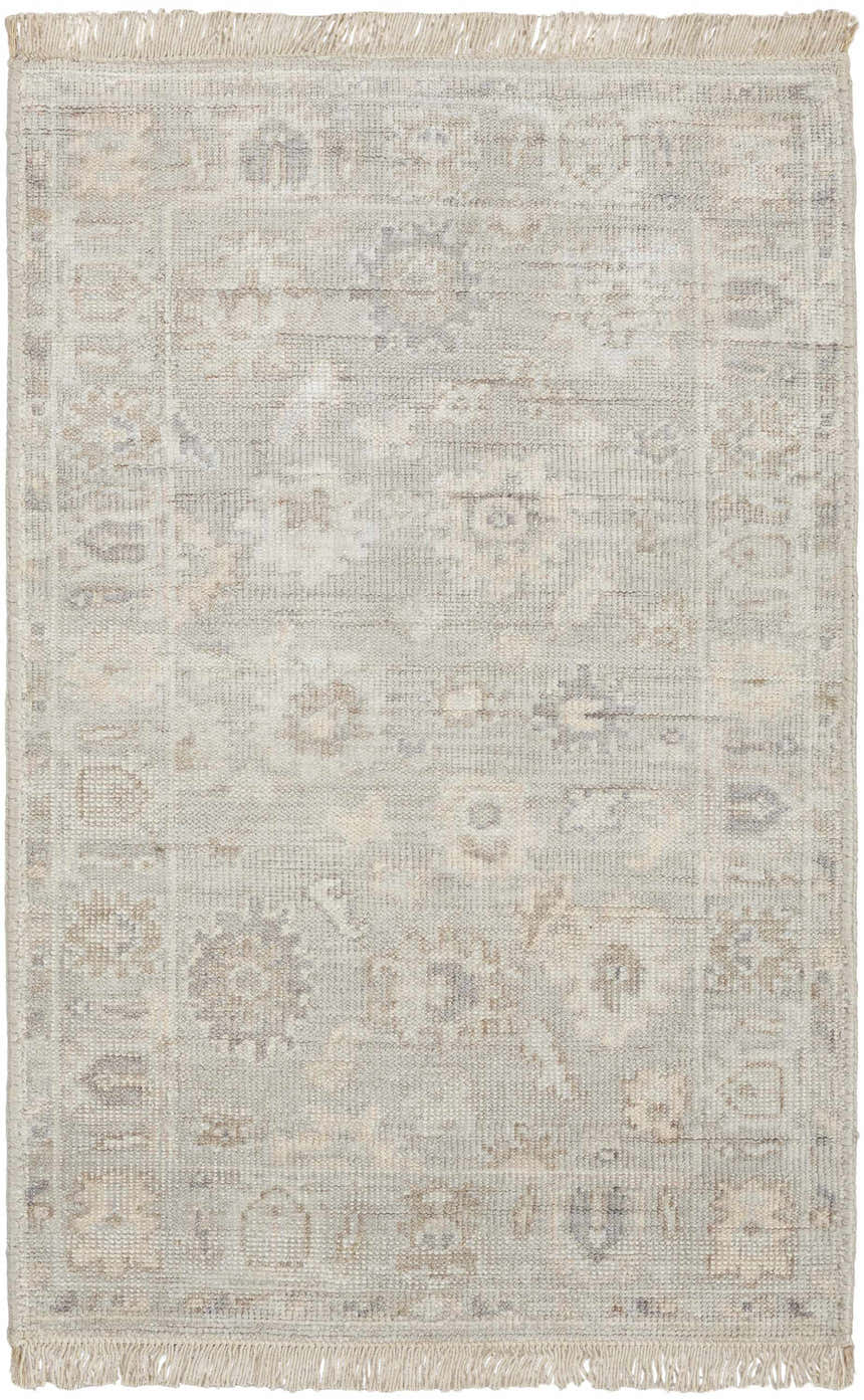 Close-up of the handmade Nourison Aldora Silver Blue vintage rug with a subtle floral pattern and fringe.