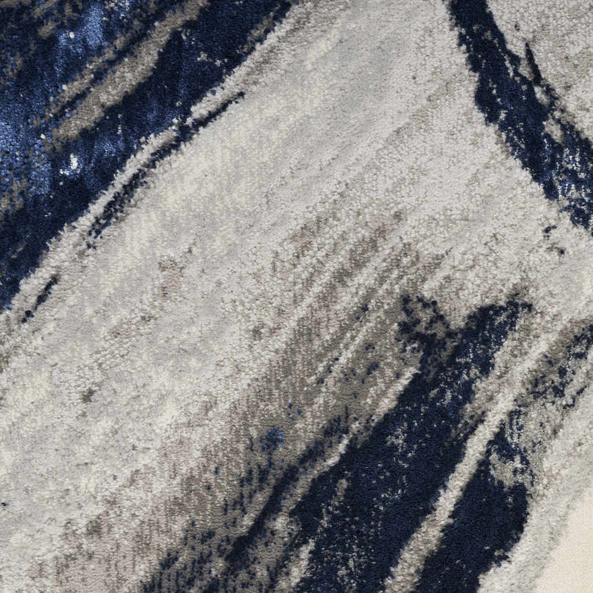 Close-up of the Nourison Splash Grey Navy rug. Abstract design with gray and navy brushstrokes. Soft, textured pile.