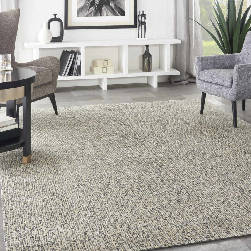 Modern living room with gray armchairs and Nourison Starlight Midnight area rug.