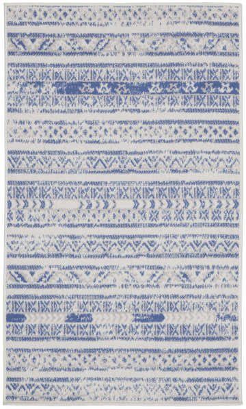 Close-up of Nourison Whimsicle Ivory Blue rug. Bohemian style with horizontal stripes and geometric patterns.