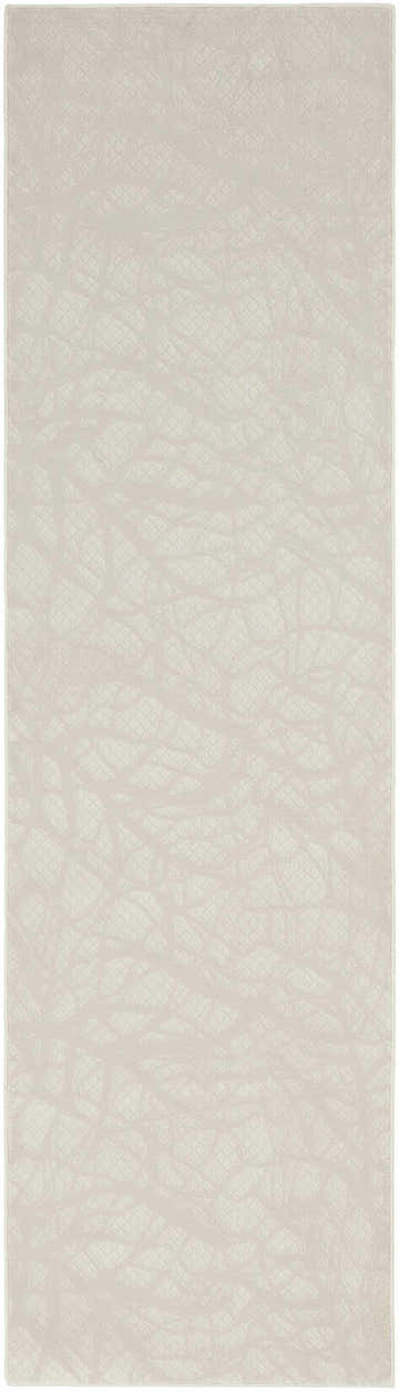 Close-up of the Nourison Desire Beige rug. Features a subtle, abstract branch-like pattern and soft, neutral tones.