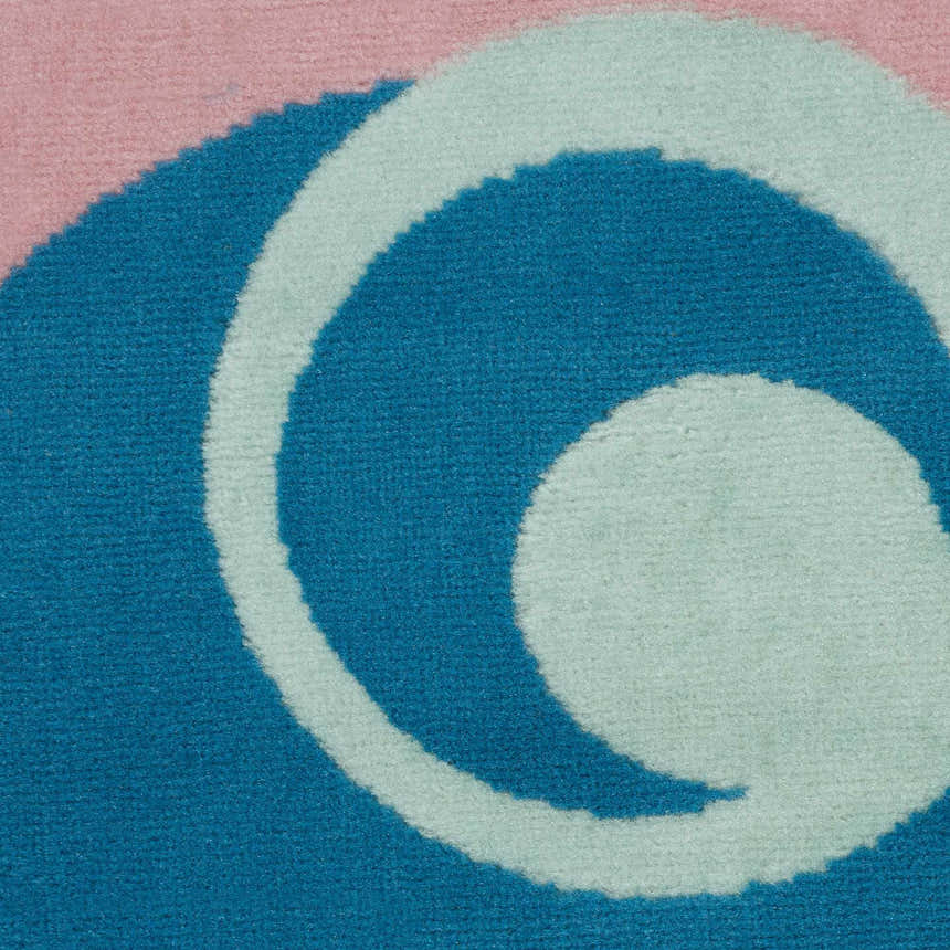 Close-up of the Nourison Grafix Blue Multicolor rug, showing the abstract swirl pattern and soft, textured pile.