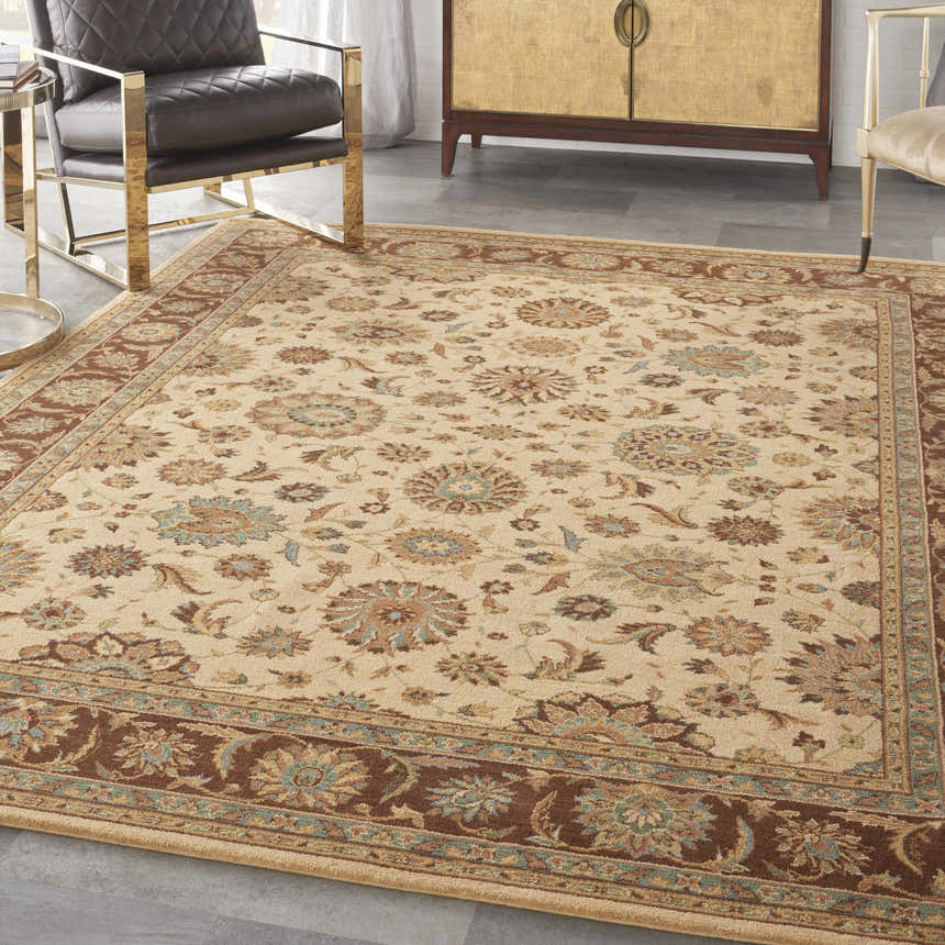 Living room scene with a Nourison Living Treasures Beige rug, leather chair, and gold accent furniture.