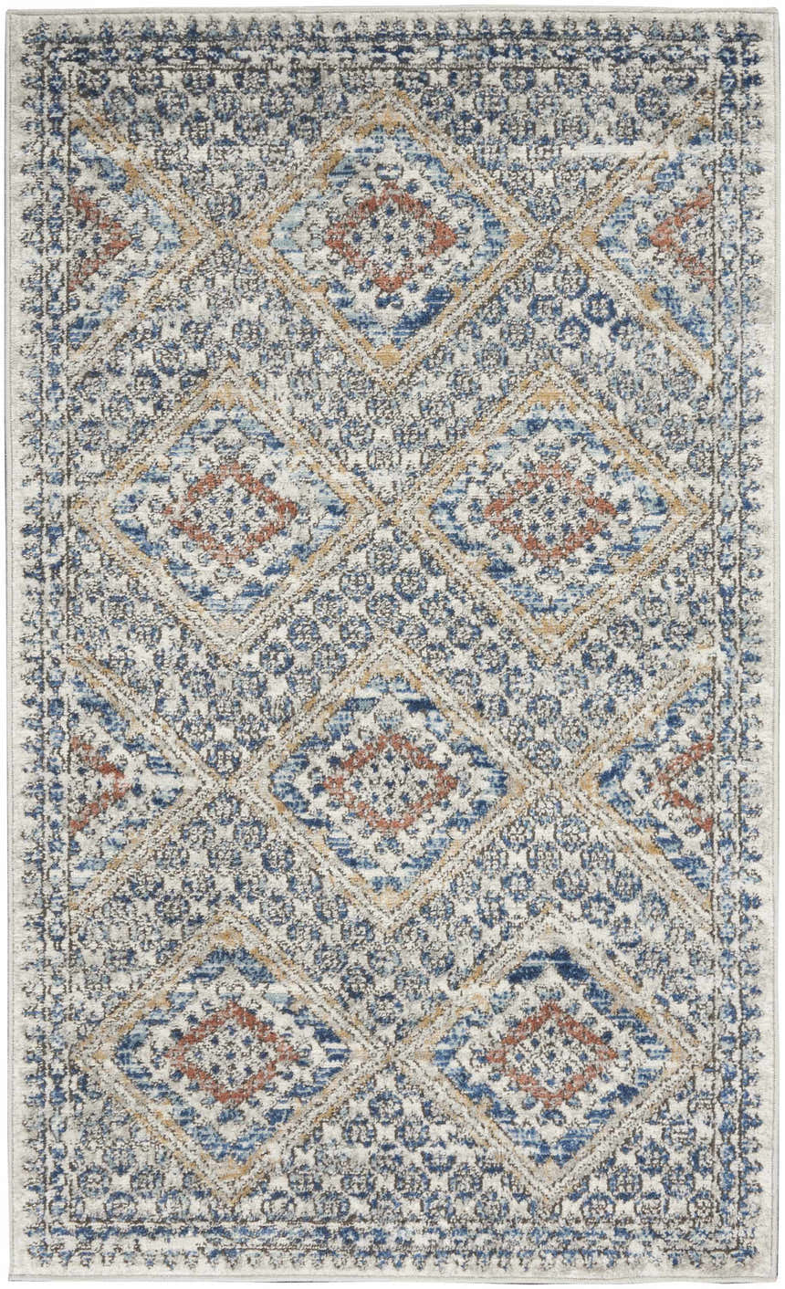 Close-up of Nourison Quarry Blue Ivory Southwestern rug. Diamond pattern in chestnut, blue, and ivory. Machine made.