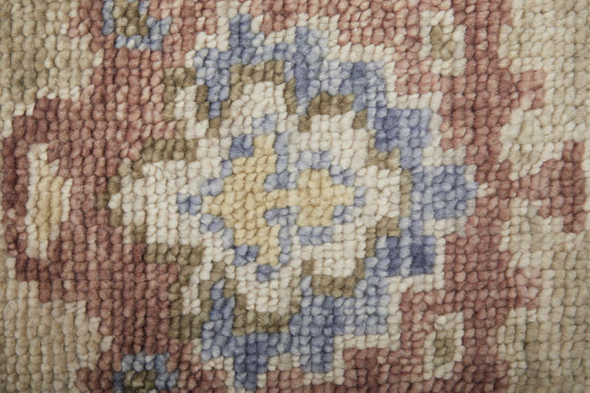 Close-up of Feizy Fillmore rug. Hand-knotted wool texture in brown, tan, and blue floral and botanical design. Texture