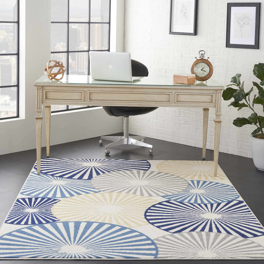 Contemporary office with Nourison Grafix White rug featuring blue, gray, and beige circles under a glass-top desk.