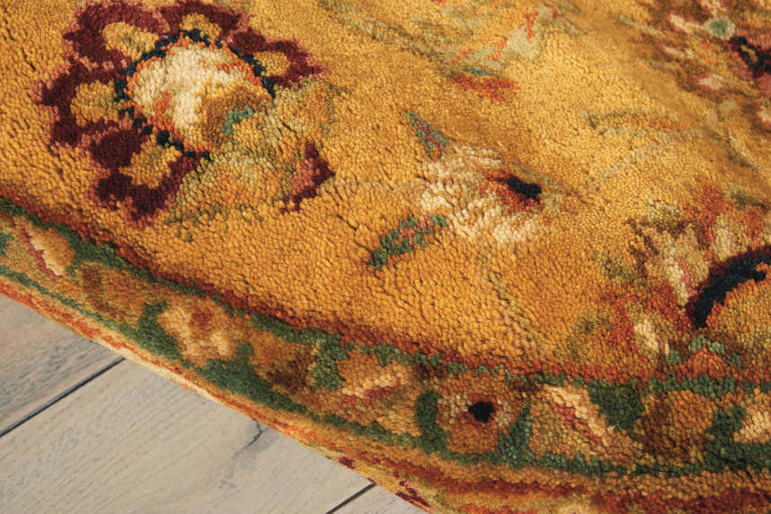 Close-up of the handmade Nourison Jaipur Gold rug. Wool rug features floral design in gold, burgundy, and green tones.