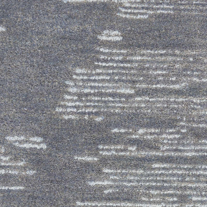 Close-up of the handmade Michael Amini Ma30 Star Blue rug. Light blue wool with a subtle, modern stripe pattern.