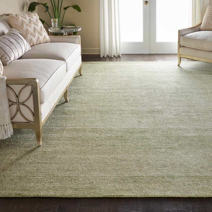 Living room scene with a citron Nourison Weston rug, cream sofa, and dark wood floors.