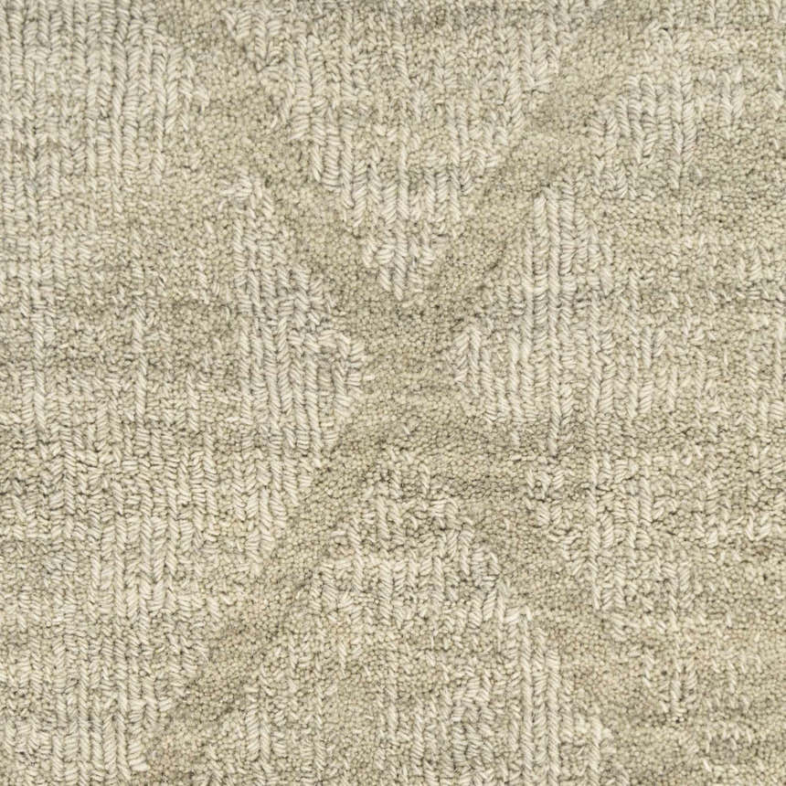 Close-up of the textured Nourison Wool Haven Sage rug. Muted sage and charcoal wool pile, handmade construction.