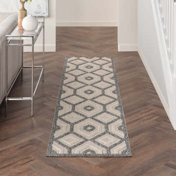 Hallway styled with Nourison Cozumel Cream rug runner. Modern geometric design on dark wood herringbone floors.