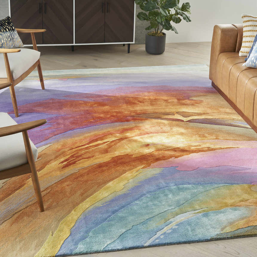 Living room scene with a multicolor Nourison Prismatic rug, tan leather sofa, and mid-century modern chairs.
