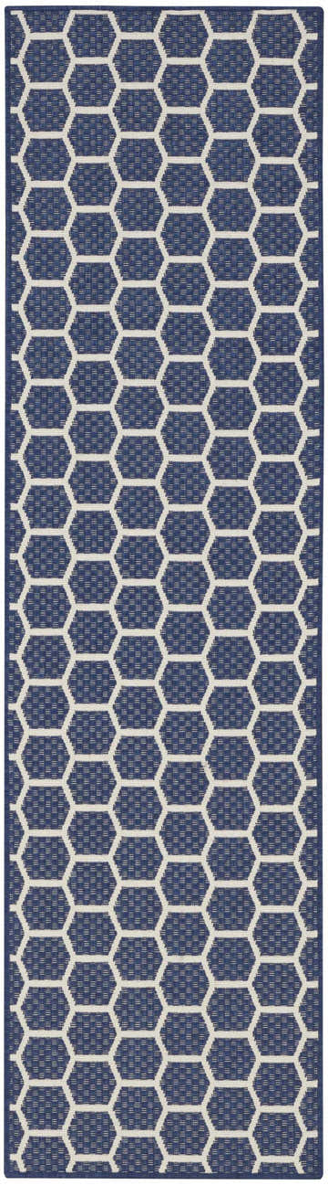 Close-up of Nourison Twist Reversible Navy Modern Area Rug, featuring a geometric honeycomb pattern. Navy and white color scheme.