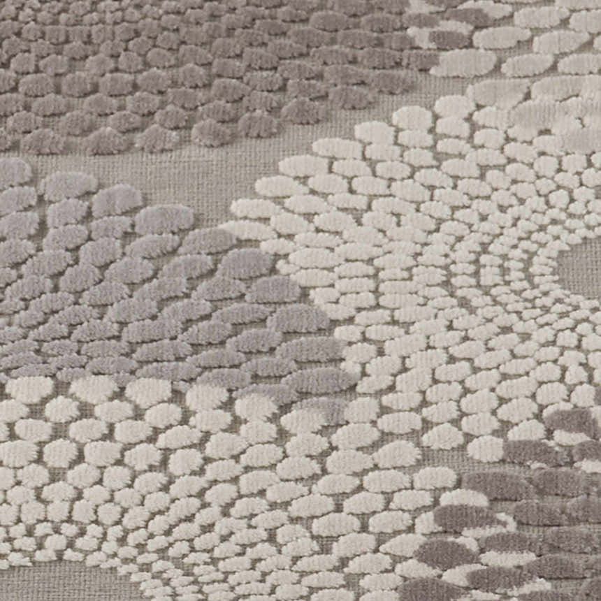 Close up of the grey Nourison Graphic Illusions rug with a raised, textured geometric pattern.
