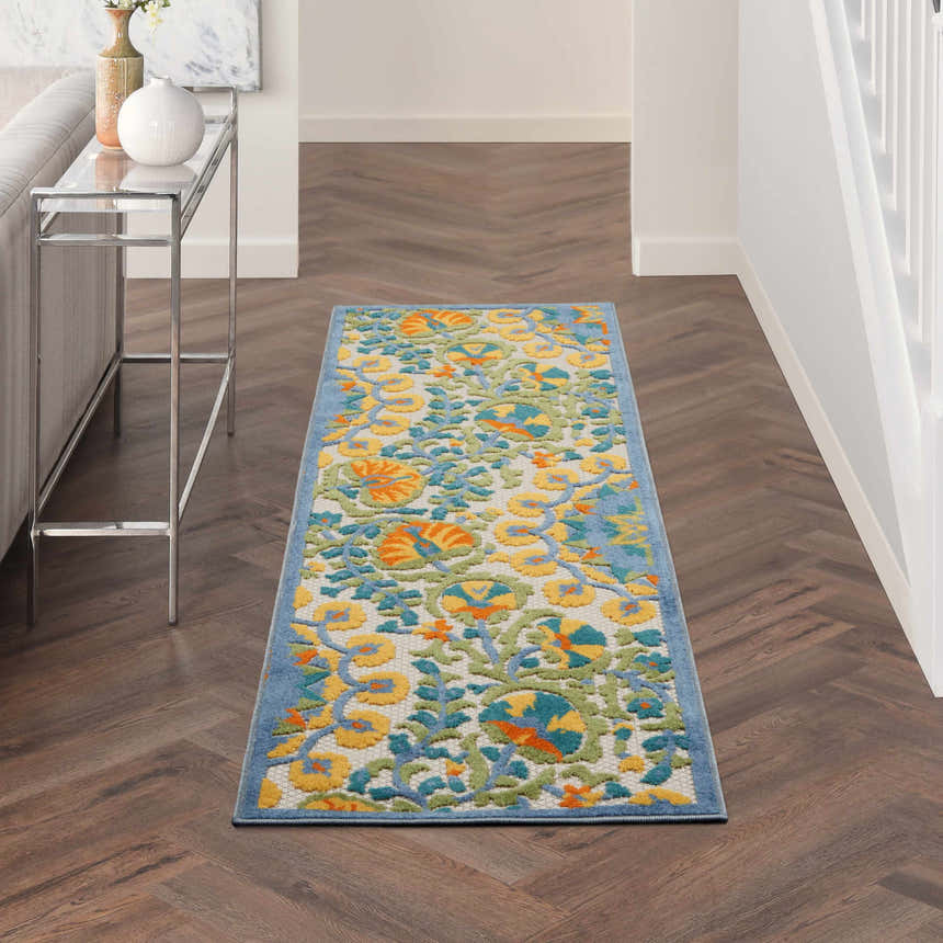 Hallway scene with Nourison Aloha Multicolor rug runner, silver console table, herringbone wood floors.