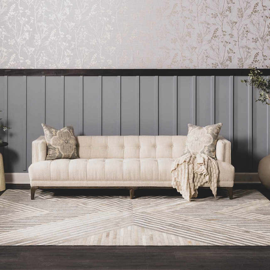 Living room scene with a beige sofa on a geometric Akiye Area Rug in cream, beige, and gray. Roomscene-Rectangle