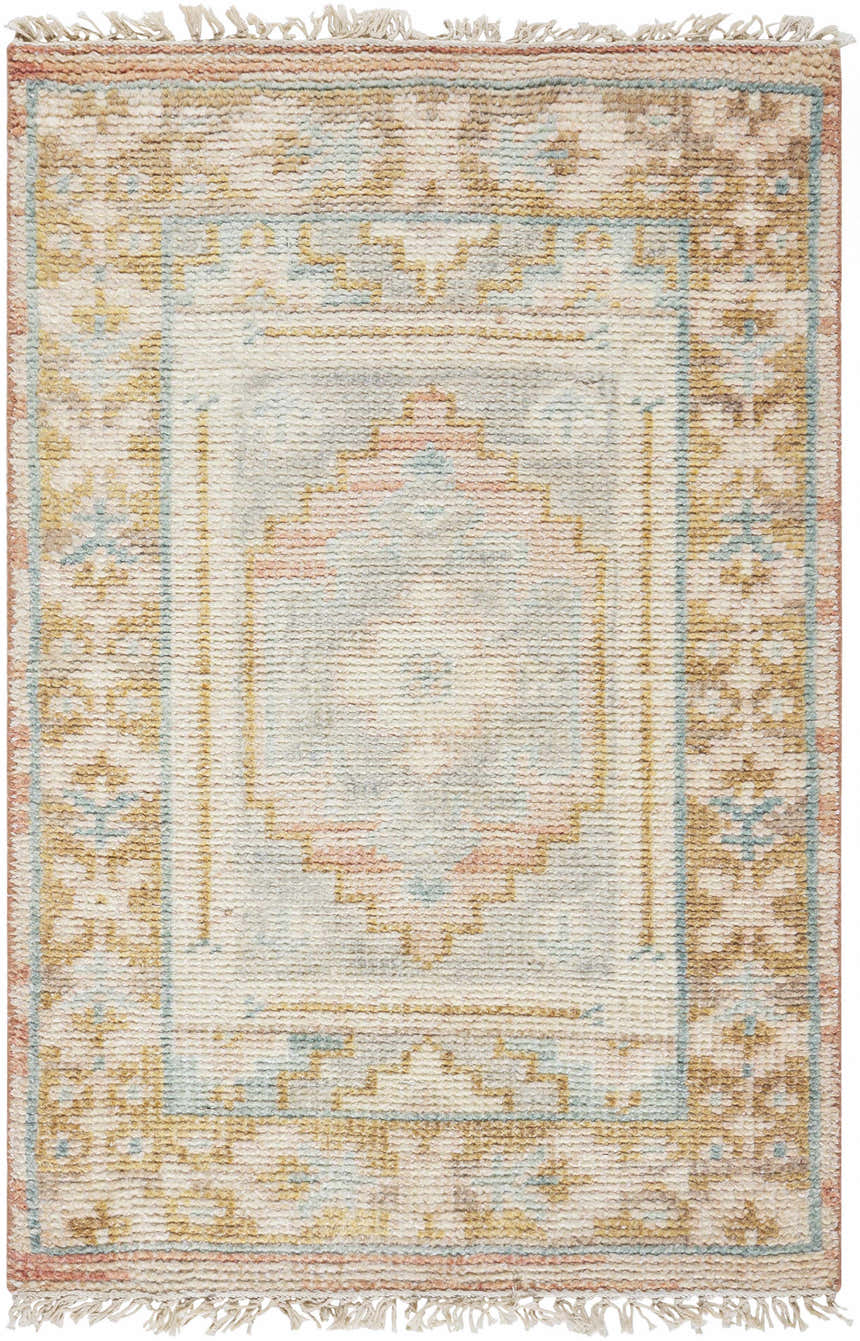 Close-up of the hand-knotted Aliang Premium Rug. Features a traditional pattern in cream, blue, tan, and dusty pink hues. Design-Rectangle-23