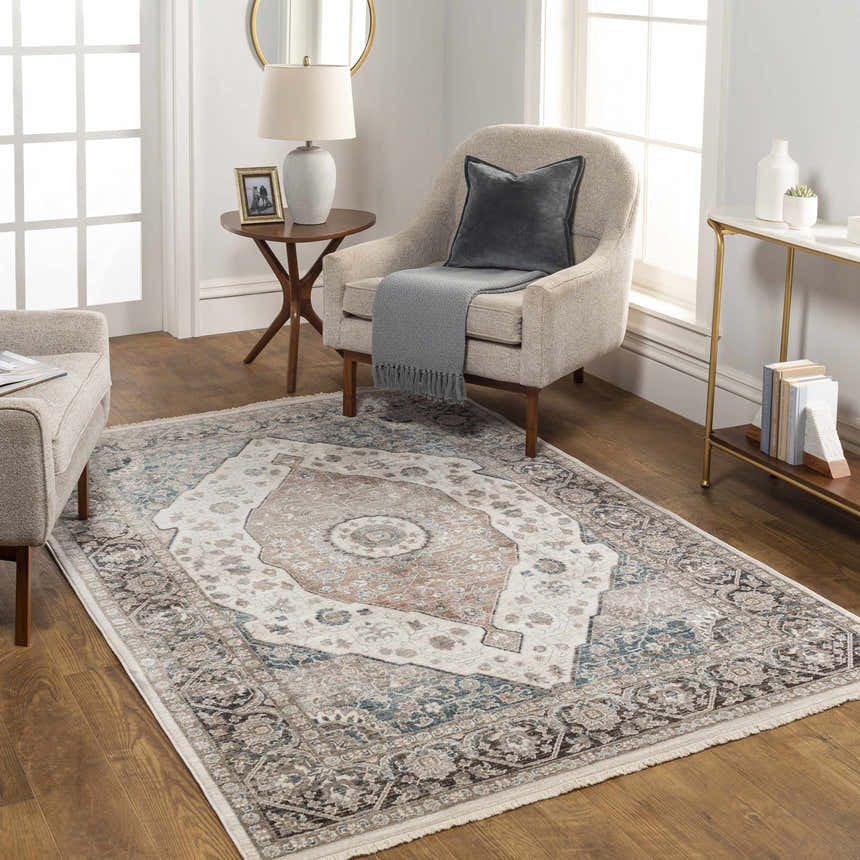 Living room scene with a cream chair and the traditional Baychester Area Rug in cream, denim, and brown tones. Roomscene-Rectangle
