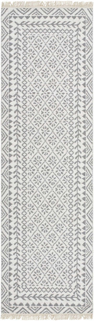 Close-up of the hand woven Bayou Area Rug. Features a gray and beige farmhouse-style geometric pattern and tasseled edges. Design-Runner-268