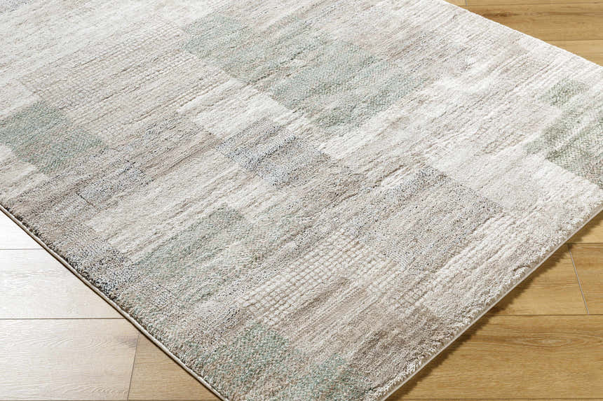 Close-up of the Anaisa Ivory Luxe Thick Area Rug showing its ivory, sage, and tan contemporary design and plush texture. Corner