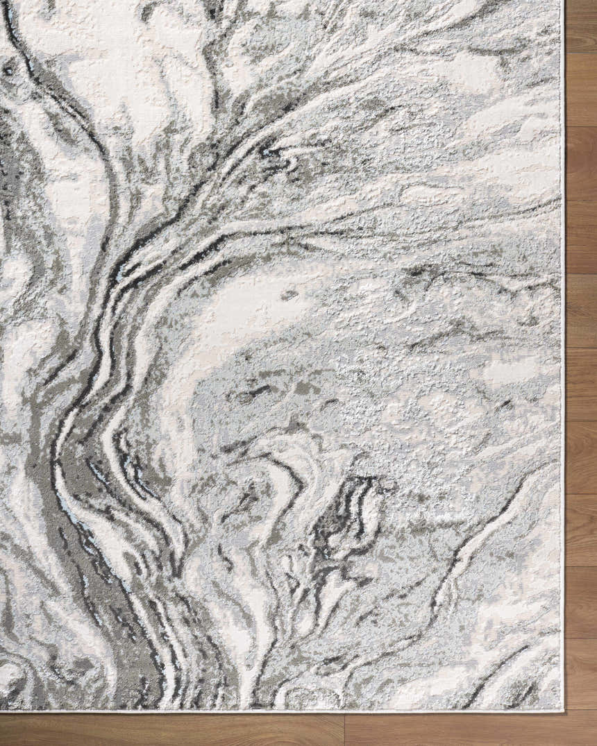 Close up of the Brandi Gray Marble Area Rug, showcasing its beige, gray, and ivory marble-like pattern and texture. Corner