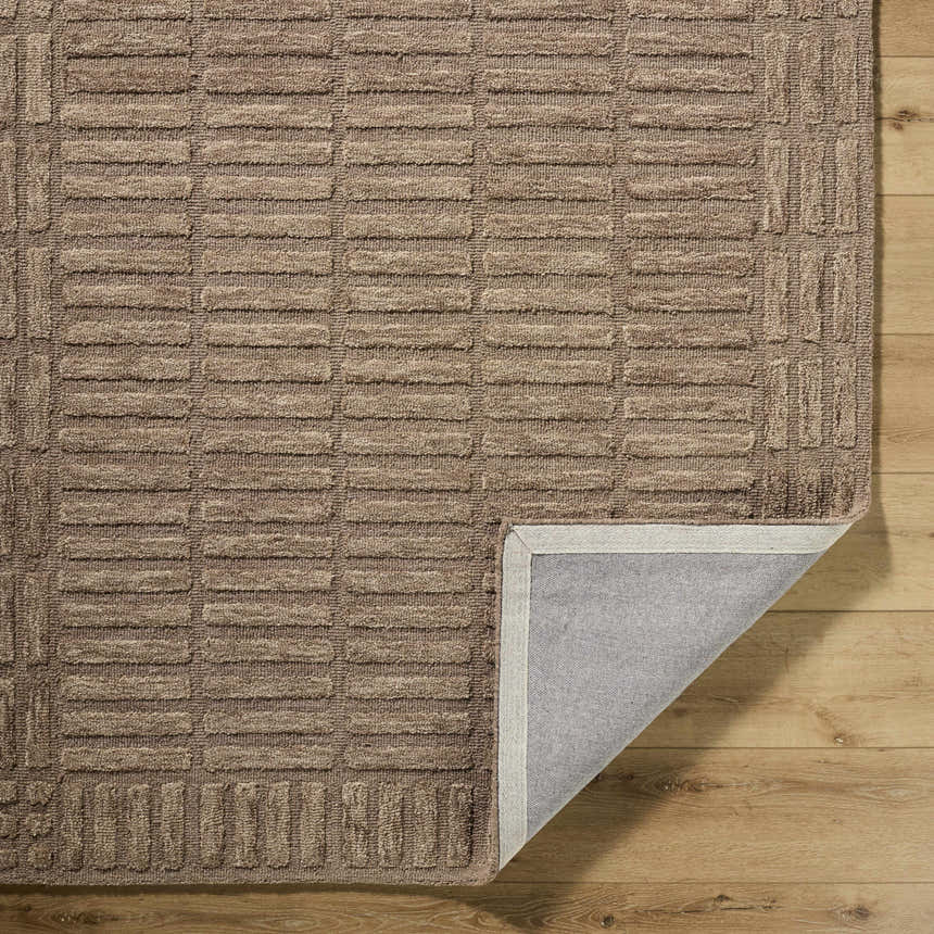 Close-up of the hand-tufted Birger Beige Area Rug showing its wool texture and contemporary sandstone and taupe geometric pattern. Fold