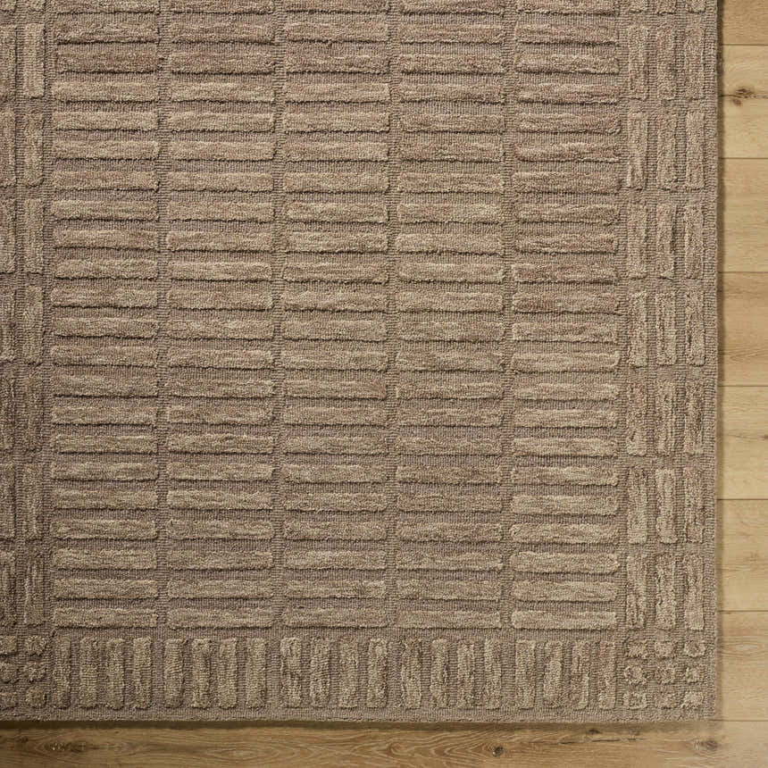 Close-up of the beige Birger Area Rug. Hand-tufted wool rug with a contemporary block pattern and textured design. Corner
