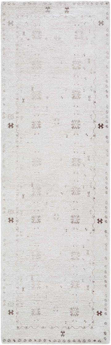 Close-up of the hand-tufted Bhavna Area Rug. Ivory rug with a subtle sandstone and taupe traditional pattern. Design-Runner-268