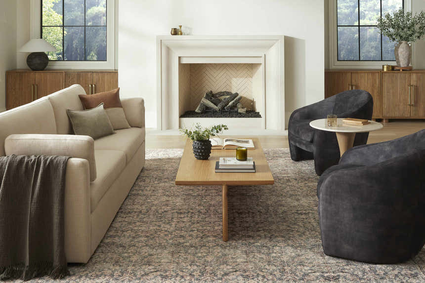 Living room scene with a beige sofa and the Galey Alix x LIVABLISS Collins Avenue area rug in beige, red, and green. Roomscene-Rectangle