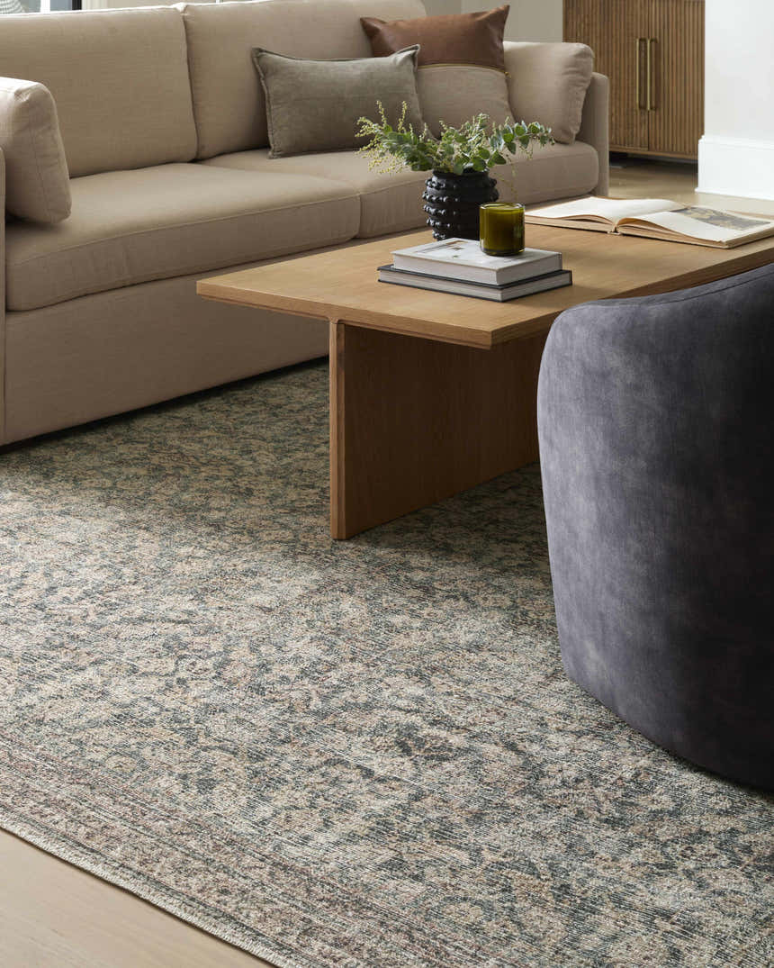 Living room scene with a beige sofa and the Galey Alix x LIVABLISS GACA-2302 Collins Avenue area rug in beige, red, and green. Styleshot