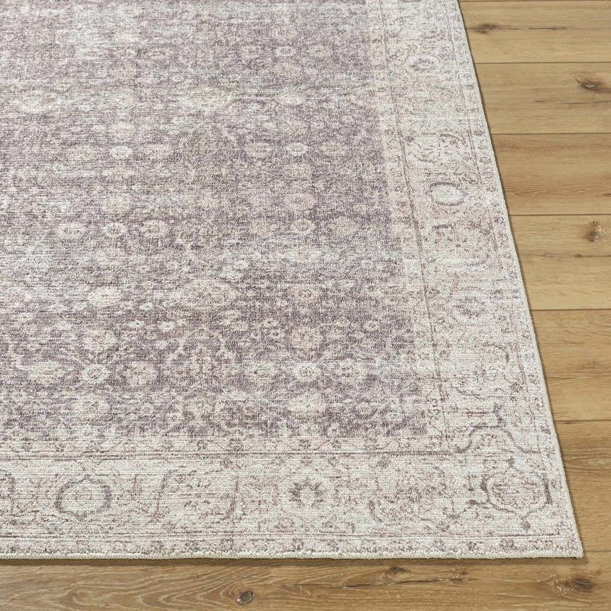 Close-up of the beige and cream Spokane Machine Woven PNWSP-2302 area rug with a traditional design on wood floors. Front