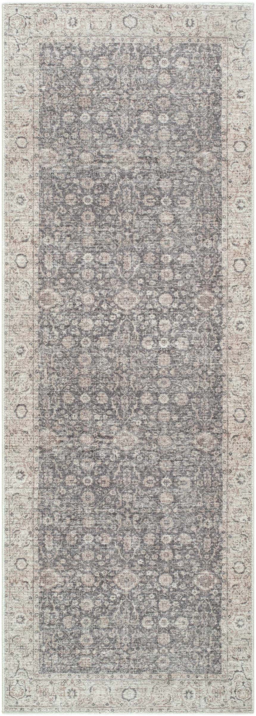 Close-up of the Spokane Machine Woven rug. Features a traditional floral pattern in charcoal, ivory, and tan. Design-Runner