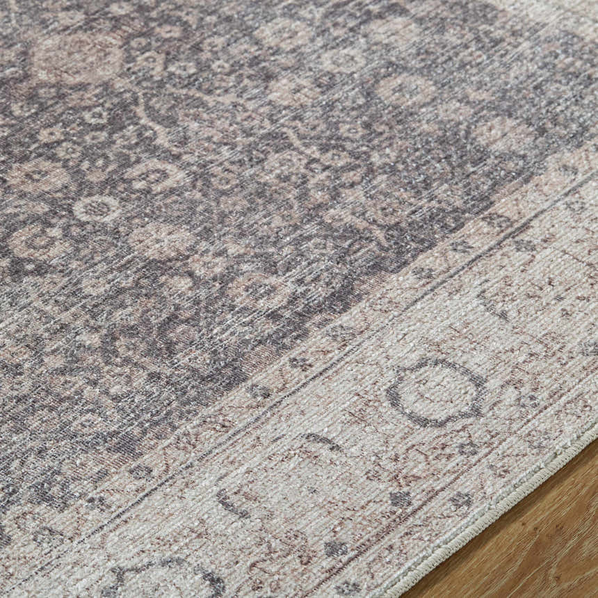 Close-up of the Spokane Machine Woven rug. Features traditional charcoal, ivory, and tan farmhouse pattern and textured weave. Texture