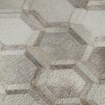 Close-up of Dalyn Luxury Bozeman BM1 Gray Washable Area Rug featuring a geometric, patchwork design in beige, black, and taupe.
