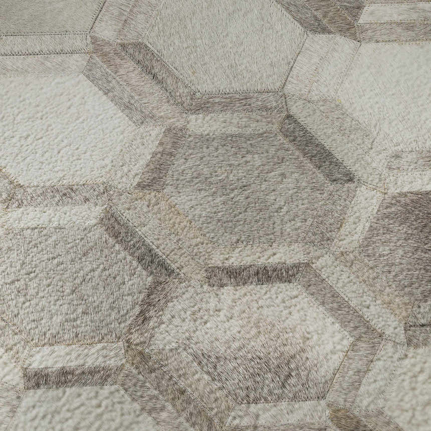 Close-up of Dalyn Luxury Bozeman BM1 Gray Washable Area Rug featuring a geometric, patchwork design in beige, black, and taupe.