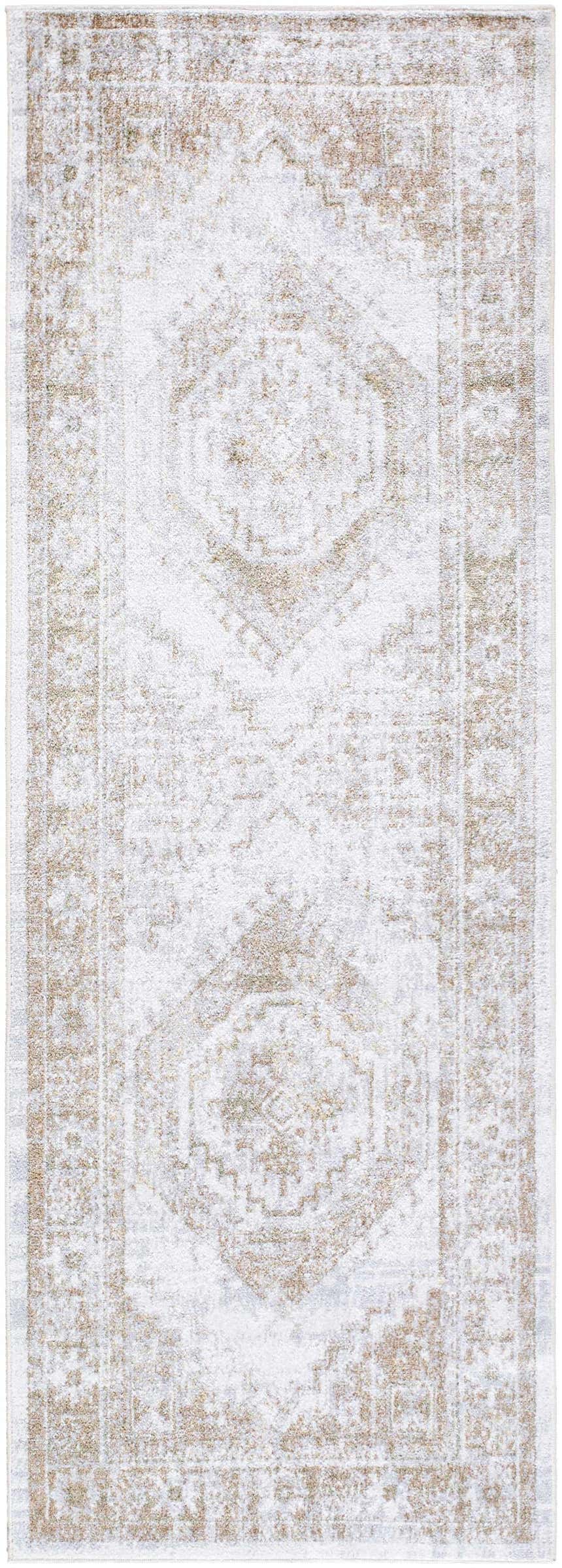 Close-up of the Bienne Washable Area Rug. Beige and tan traditional farmhouse rug with a distressed, intricate pattern. Design-Runner-2773