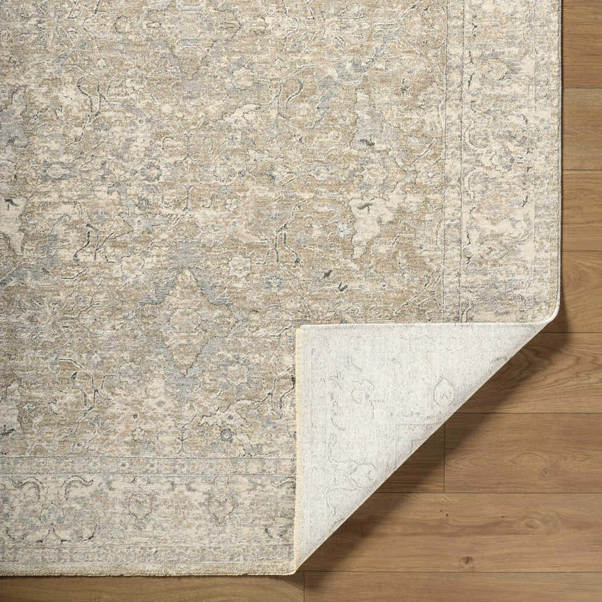Close-up of Brynja Cream Area Rug showing traditional pattern and texture on wood floor. Fold